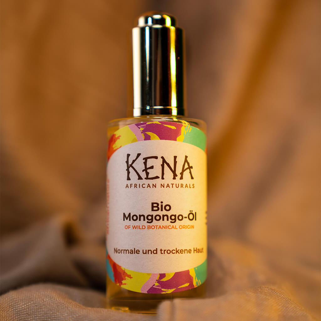 KENA Bio Mongongo-Öl Glasflasche in Nahaufnahme mit goldener Dropper Pipette mit natürlichem Hintergund.